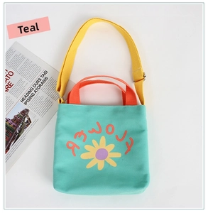 Close-up of cyan canvas kids bag with orange handles and yellow daisy flower print