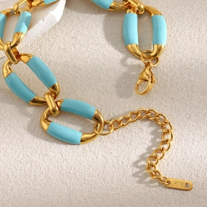 Detail of 18K gold-plated chain bracelet with blue enamel inlay and K18 hallmark