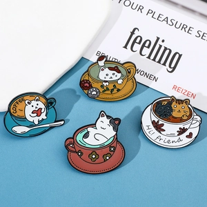 Detail of four cartoon enamel pins featuring cute cats and rabbits in coffee cups