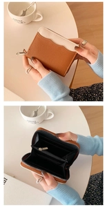 Detail of two-tone leather coin purse showing interior card slots and zipper closure