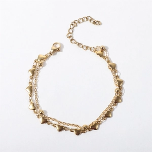 Double-layered golden stainless steel heart bracelet with spacer beads and lobster clasp