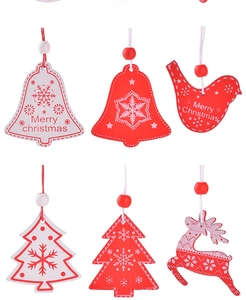 Detail of red and white wooden Christmas ornaments with snowflake patterns and Merry Christmas text