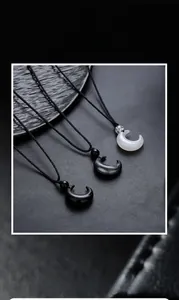 Detailed view of three crescent moon pendants in marble stone with handwoven black cords