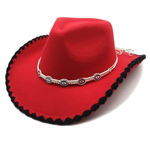 Detail of red wool felt cowboy hat with evil eye bead trim and black braided edges