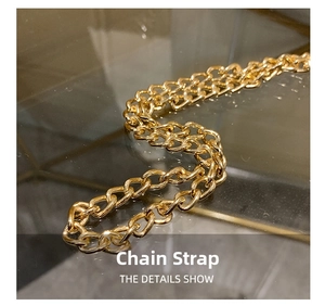 Detailed close-up of a polished gold metal chain shoulder strap for handbags