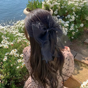Elegant large black tulle bow hair clip with flowing ribbons for women's hairstyle