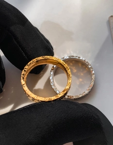 Macro detail of 18k gold plated hammered texture ring with EMMA engraving inside