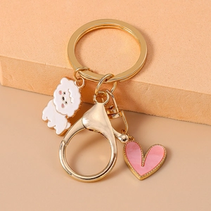 Cute golden keychain with white cartoon puppy and pink heart charm for bag accessory