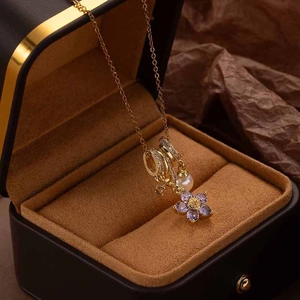 Elegant gold titanium steel necklace featuring a purple zircon flower and pearl pendant