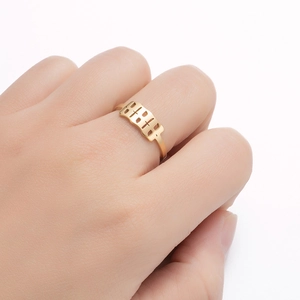 Detailed view of adjustable gold stainless steel ring with 1994 cutout number design