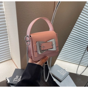 Detailed view of pink mini crossbody bag with silver square buckle and chain strap