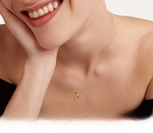 Detail of gold S925 silver necklace featuring a colorful zircon pendant with letter R
