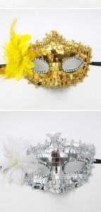 Detailed close-up of Venetian style sequin party masks with silk flowers and feather accents