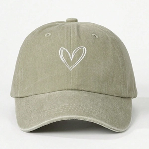 Close-up of heart embroidery on washed cotton baseball cap with vintage finish