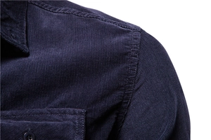 Detailed close-up of shoulder seam and corduroy texture on navy blue long sleeve shirt