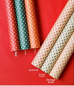 Close-up of waterproof polka dot wrapping paper in red, green, orange, and kraft colors