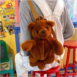 Detail view of a plush teddy bear backpack with soft brown faux fur and adjustable straps