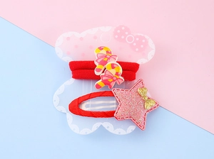 Detail of red candy cane hair tie and glittery star hair clip for children