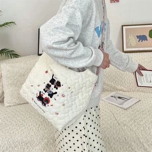Detail of quilted cat tote bag with pink strap and 'Have a nice day' embroidery