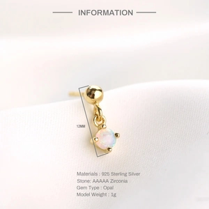 Macro detail of gold 925 sterling silver star earring with opal and zirconia inlay