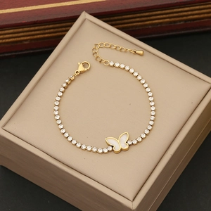 Detail of gold butterfly bracelet with shell inlay and sparkling zircon stone setting