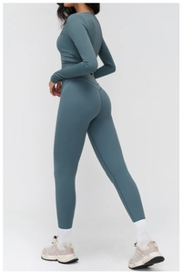 Rear view of sleek brushed yoga set showing slim fit long sleeve top and high waist leggings