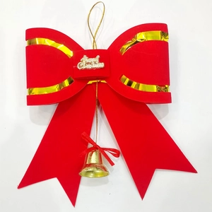 Red flocked Christmas bow with golden Merry Christmas plate and festive bell hanging