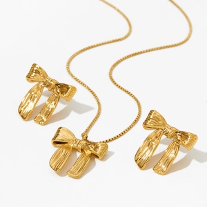 Golden butterfly jewelry set featuring necklace and earrings on a clean white background