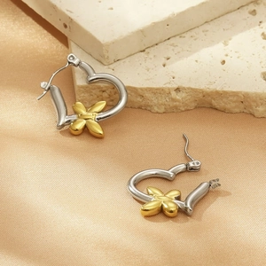 Elegant silver heart-shaped earrings with gold butterfly detail on stone and silk