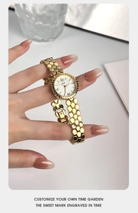 Detail view of lady gold bracelet watch featuring a creative honeycomb strap design