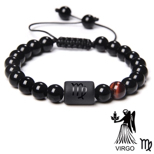 Detail of beaded Virgo constellation bracelet with black beads and tiger eye stone accent