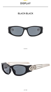 Detail view showing black Y2K oval sunglasses with hollowed silver metal temple design