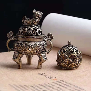 Detail of vintage bronze incense burner with intricate lion lid and floral carvings