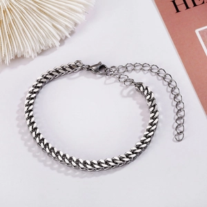 Polished stainless steel Cuban chain bracelet with lobster clasp on a clean white surface