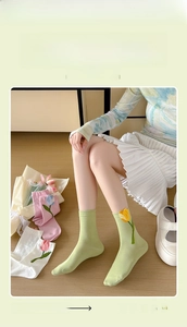 Detail showing tulip embroidery on soft macaron green combed cotton crew socks