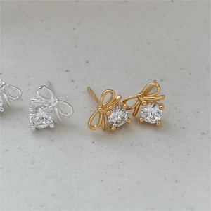 Minimalist 925 sterling silver bow knot stud earrings with round cubic zirconia stones