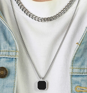 Close-up of men's double layer stainless steel necklace with black square pendant