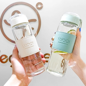 Minimalist glass water bottles with beige and green heat-resistant faux leather sleeves