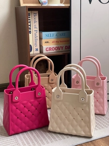 Detail of colorful EVA beach bags featuring quilted texture and perforated hole design