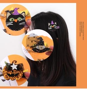Detail view of sequined Halloween hair clips featuring pumpkin, black cat, and witch hat motifs