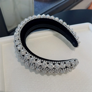 Detailed view of luxury baroque headband with sparkling rhinestones on black fabric base