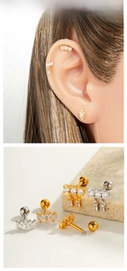 Detailed view of copper zircon cartilage studs in teardrop and geometric shapes