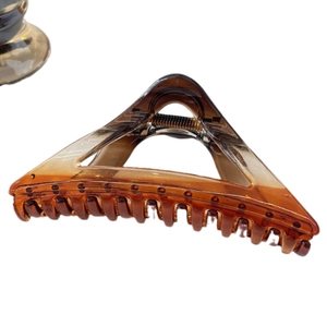 Translucent amber tortoise shell hair claw clip with geometric triangle shape