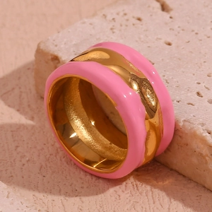 Detail of pink enamel ring with irregular 18K gold plated water wave pattern texture