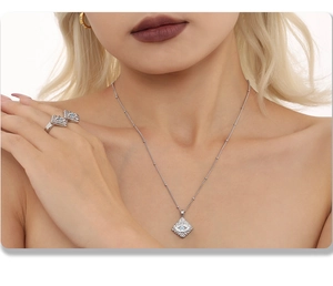 Detail showing rhodium-plated evil eye square pendant necklace and ring with blue stone