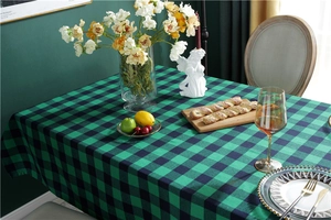 Detail of red and green plaid festive tablecloth featuring a rustic cotton-linen texture