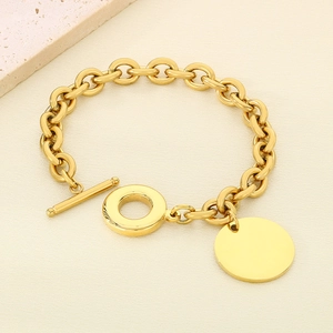 Detailed shot of golden stainless steel OT toggle bracelet with a round engravable pendant