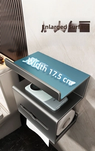 Close-up of dark grey metal toilet paper holder with top shelf on marble wall