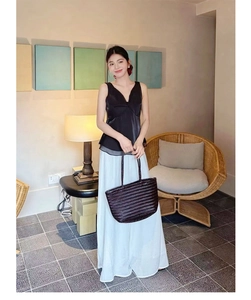 French vintage dark brown woven leather tote bag paired with an elegant pleated skirt