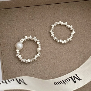 Detailed close-up of handmade irregular silver beads and freshwater pearl elastic ring